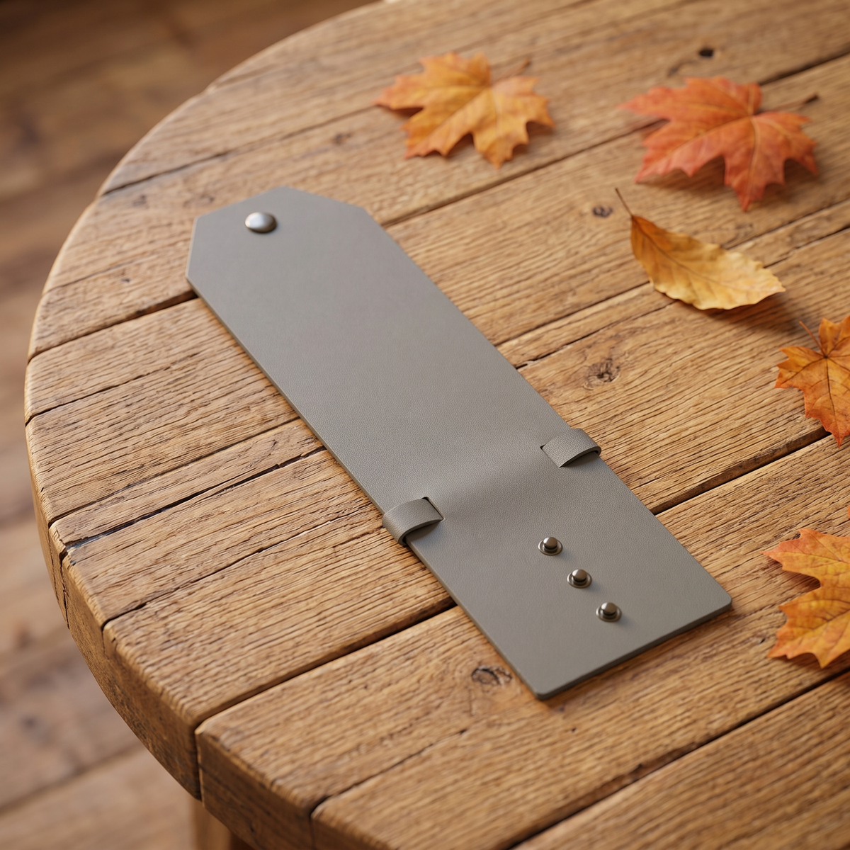 Slim cash clip on a rustic wooden table with fall leaves